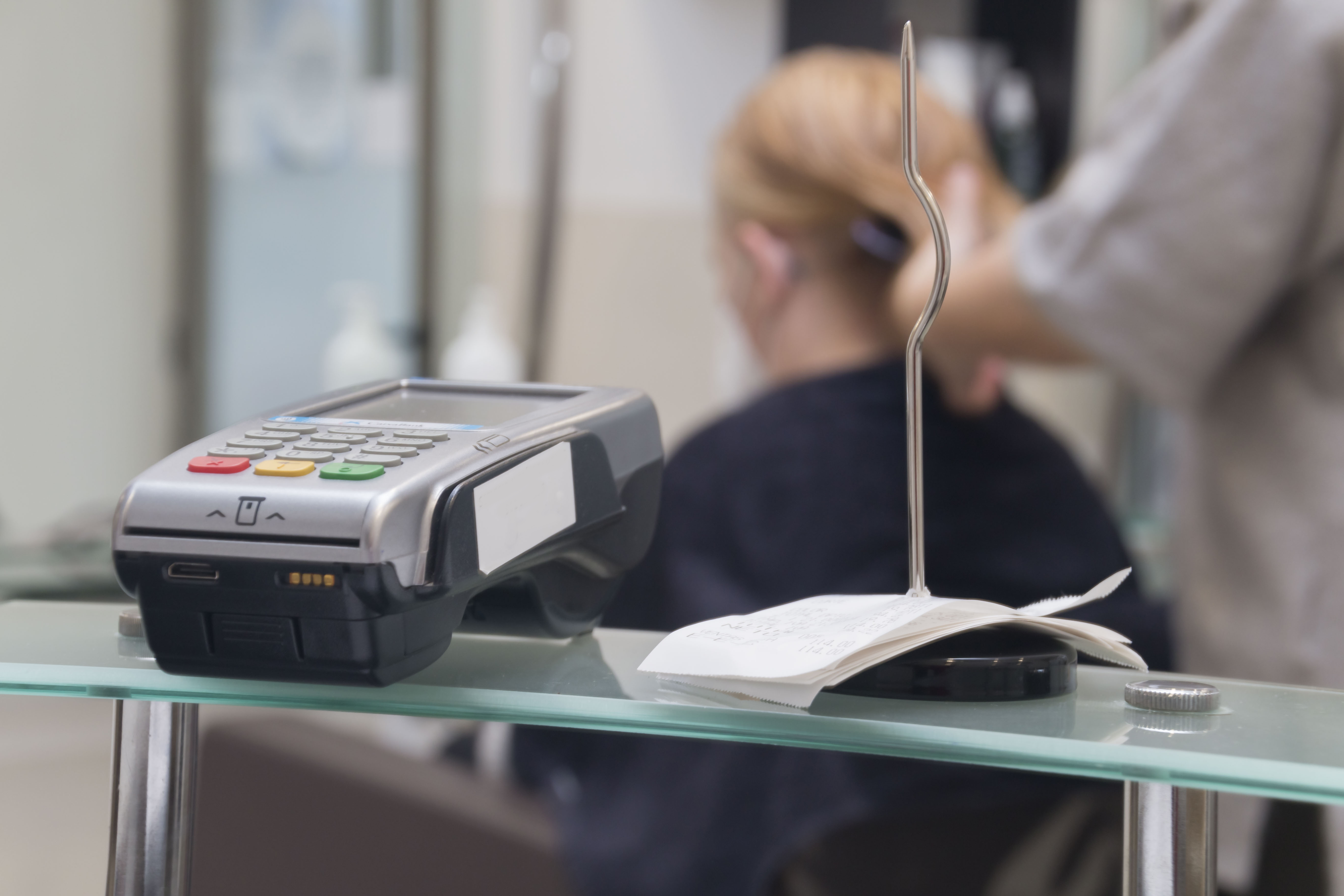 A steel check spindle and credit card terminal for receiving payments in the beauty salon